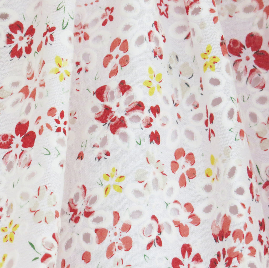 Childs Summer floral print and broderie anglaise dress fabric close up
