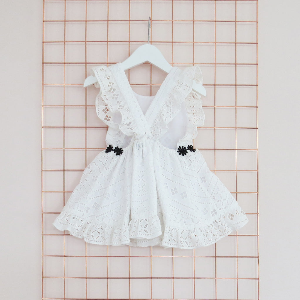 Childs Summer white cotton broderie anglaise dress with black daisy trim.