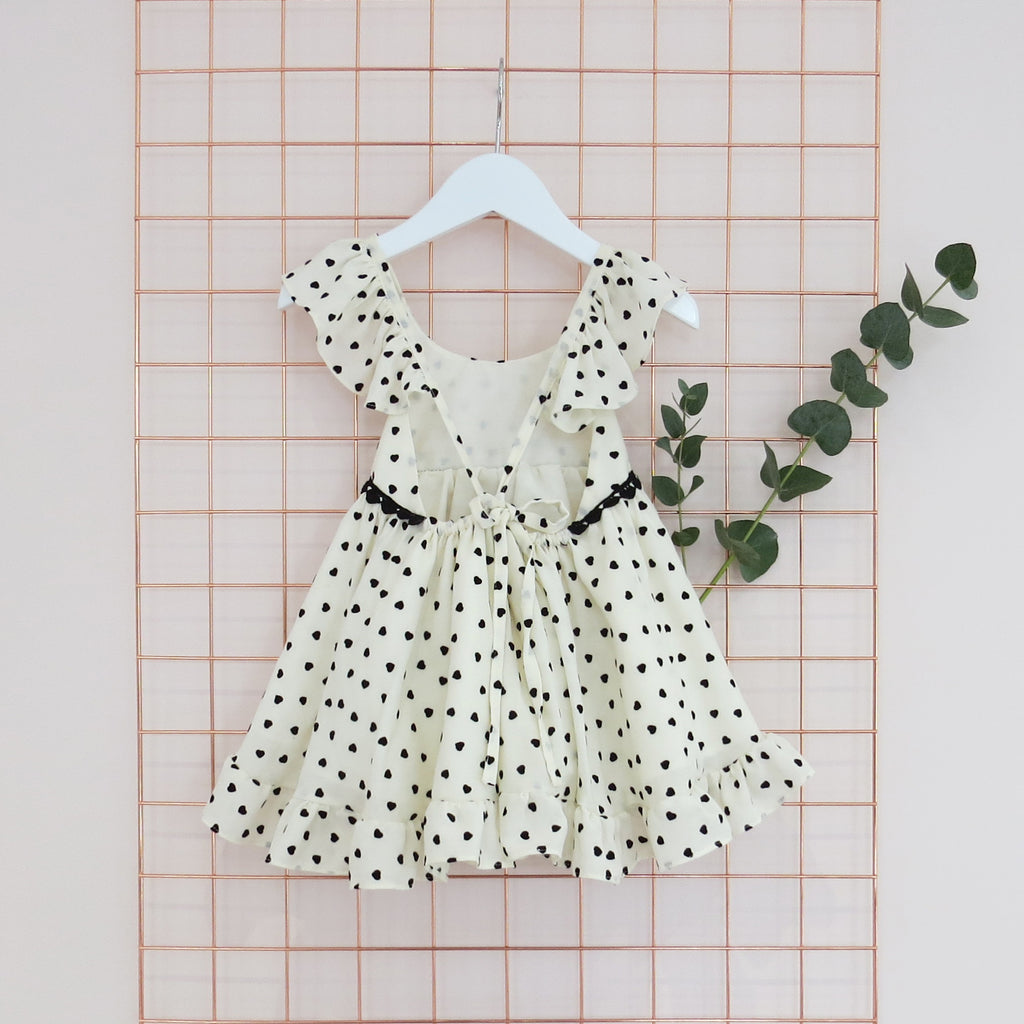 Summer Childs cream and black heart print dress with frill sleeves.