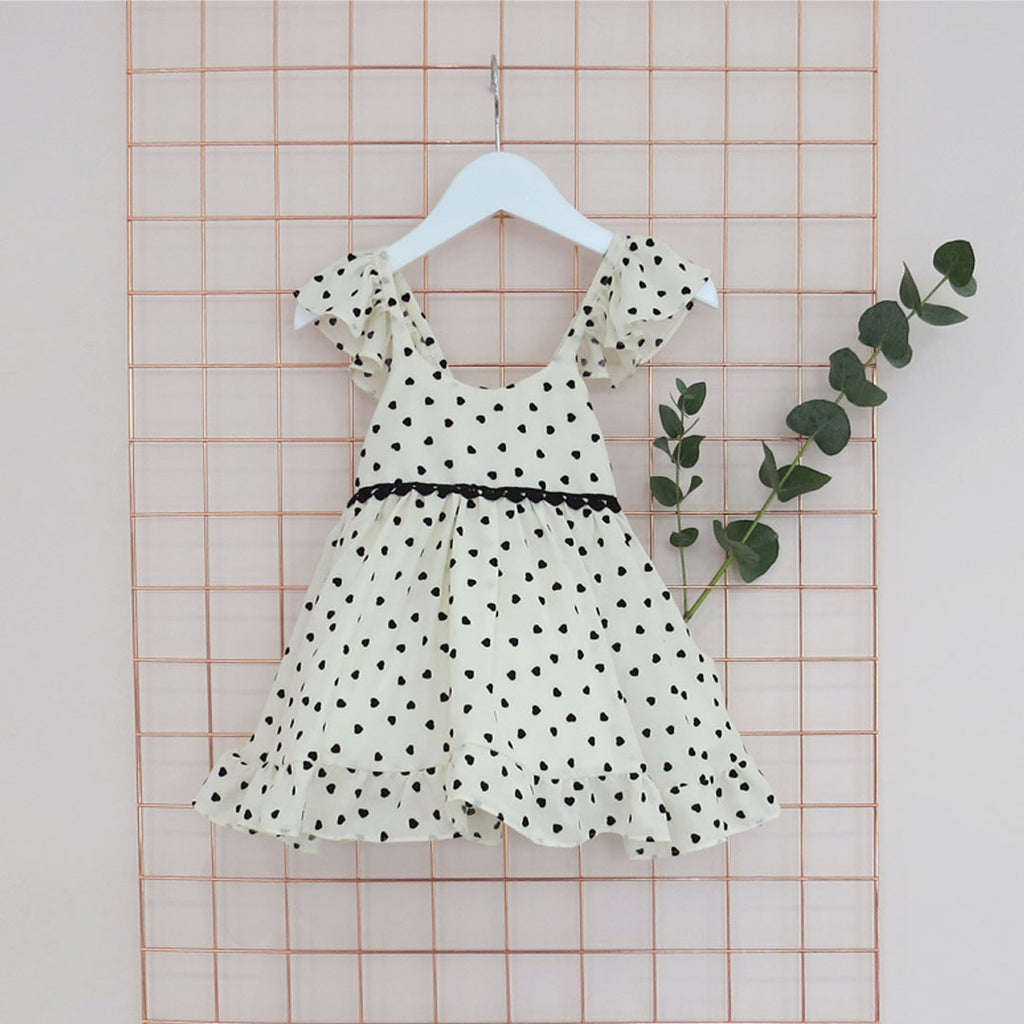 Summer Childs cream and black heart print dress with frill sleeves.