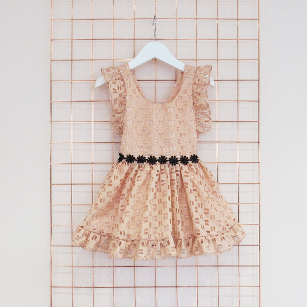 Childs Summer peach cotton geometric broderie anglaise dress with black daisy trim, rose gold foil and frill sleeves.